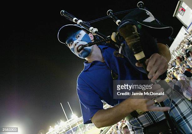 Scotland fan plays his bagpipes during the Rugby World Cup Pool B match between Scotland and Japan at Dairy Farmers Stadium October 12, 2003 in...