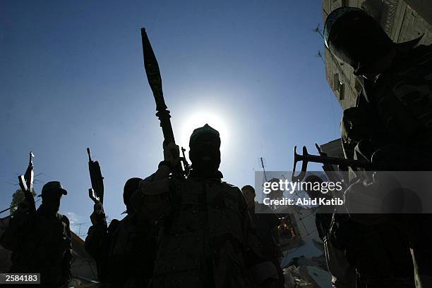 Hamas Militants inspect the rubble of several destroyed homes October 12, 2003 in Rafah Refugee Camp, Gaza Strip. Many homes were demolished during...