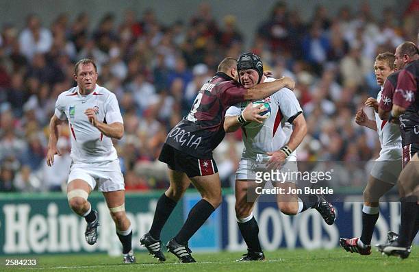 Prop Phil Vickery of England receives a high tackle from Akvensti Giorgadze of Georgia during the Rugby World Cup Pool C match between England and...