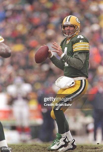 Quarterback Brett Favre of the Green Bay Packers drops back to pass during a game against the Denver Broncos at Lambeau Field in Green Bay,...