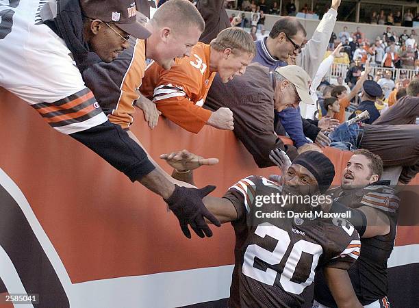 Defensive back Earl Little and offensive lineman Shaun O''Hara of the Cleveland Browns celebrate with fans after defeating the Oakland Raiders on...