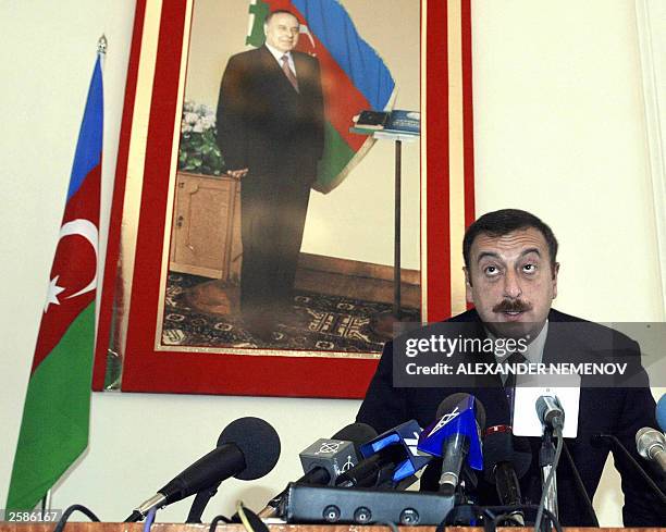 Azeri presidential candidate, Prime Minister Ilkham Aliyev, the son of current President Heidar Aliyev, takes his seat in front of his father''s...