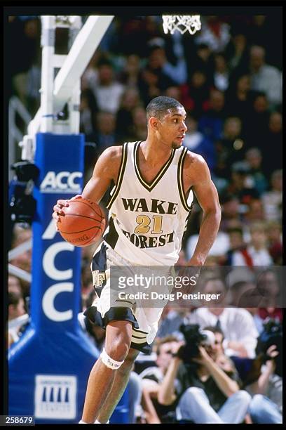 Center Tim Duncan of the Wake Forest Demon Deacons dribbles the court during a playoff game against the Florida State Seminoles at the Greensboro...