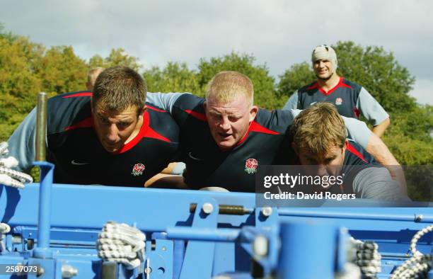 Julian White, Dorian West and Jason Leonard of England prepare to scrummage during the England rugby team''s training session on September 23, 2003...