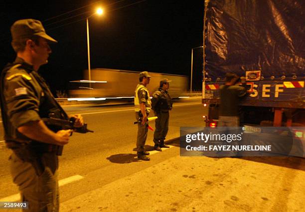Greek borderguard patrol searches a truck for illegal would-be migrants at the Greek-Turkish border region of Evros river during a patrol at the...