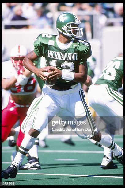 Quarterback Tony Banks of the Michigan State Spartans drops back to pass during a game against the Nebraska Cornhuskers at Spartan Stadium in East...