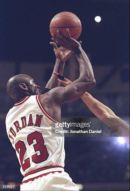 Guard Michael Jordan of the Chicago Bulls shoots the ball during a game against the Toronto Raptors at the United Center in Chicago, Illinios. The...