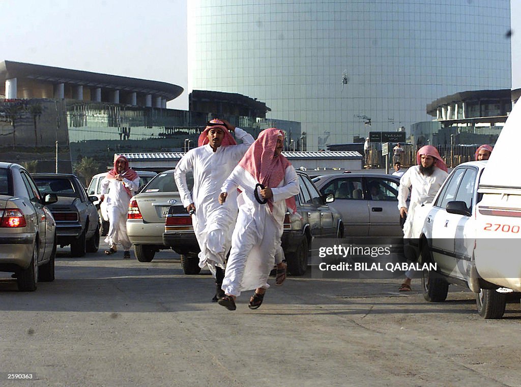 Saudi men flee from police during a prot