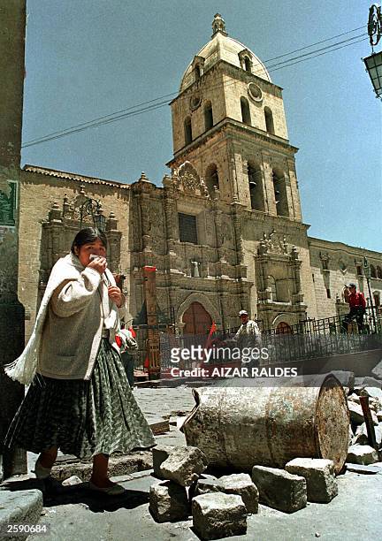 Woman walks by a blocked street in La Paz, 14 October 2003. Human rights groups are saying that at least 58 people were killed and 200 were injured...