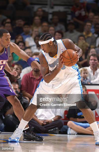 Carmelo Anthony of the Denver Nuggets looks to make a move on Shawn Marion of the Phoenix Suns during the NBA preseason game at Pepsi Center on...