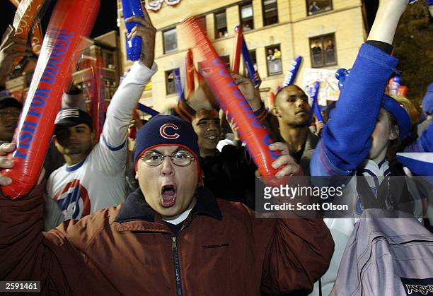 Fans celebrate outside Wrigley Field as the Chicago Cubs play the Florida Marlins in Game 6 of the National League Championship Series October 14,...