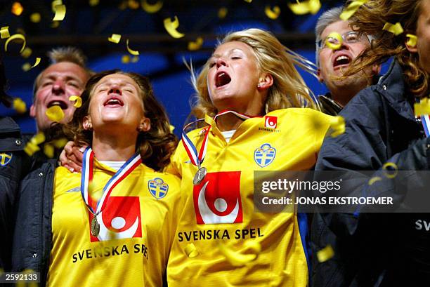 Swedish soccer players Malin Andersson and Josefin Oeqvist celebrate on stage in the Kungstraedgaarden park in central Stockholm, late 14 October...