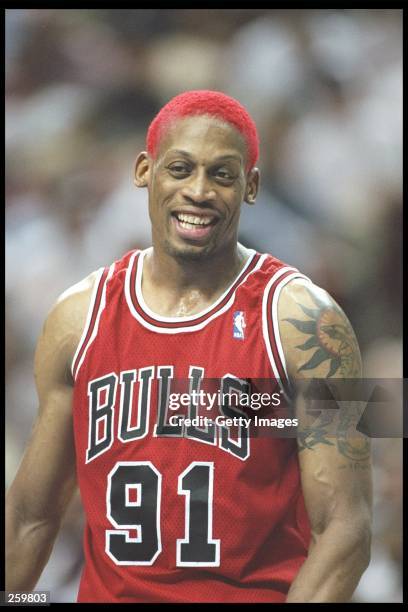 Forward Dennis Rodman of the Chicago Bulls smiles during a game against the Orlando Magic at the Orlando Arena in Orlando, Florida. The Bulls won the...