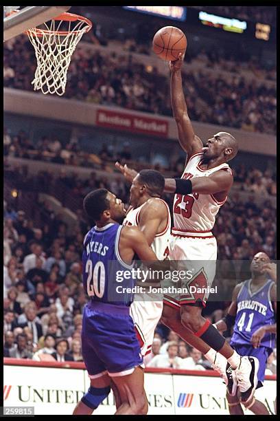 Guard Michael Jordan of the Chicago Bulls drives to the basket during a game against the Charlotte Hornets during a game at the United Center in...