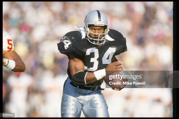 Running back Bo Jackson of the Los Angeles Raiders moves the ball during a game against the Kansas City Chiefs at the Los Angeles Memorial Coliseum...