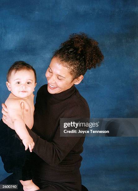 Author Mariane Pearl, widow of Daniel Pearl, holds her son, Adam Pearl, posing for a portrait on December 12, 2002 in Joyce Tenneson's studio in New...