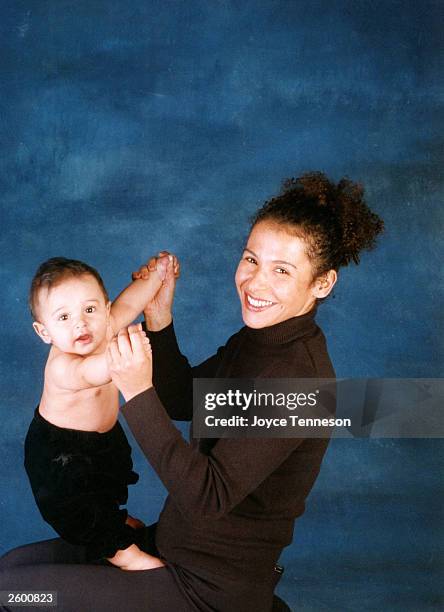 Author Mariane Pearl, widow of Daniel Pearl, holds her son, Adam Pearl, posing for a portrait on December 12, 2002 in Joyce Tenneson's studio in New...