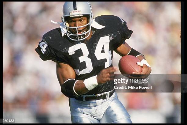Running back Bo Jackson of the Los Angeles Raiders moves the ball during a game against the Kansas City Chiefs at the Los Angeles Memorial Coliseum...