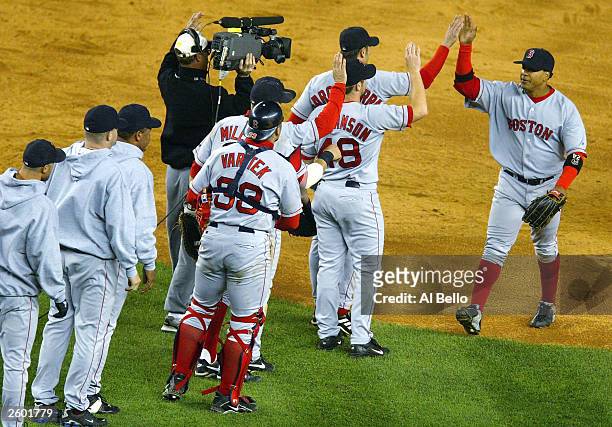 Manny Ramirez of the Boston Red Sox celebrates with the rest of the teammates after defeating the New York Yankees 9-6 in game 6 of the American...