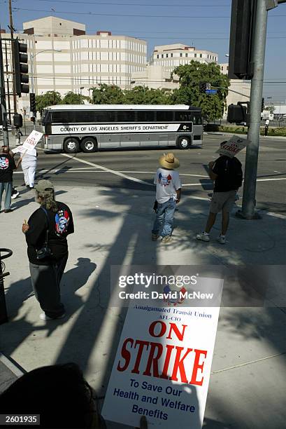 Los Angeles County Sheriff's Department prisoner transport bus passes Metropolitan Transportation Authority strikers in front of the MTA headquarters...