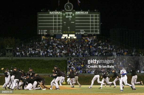The Florida Marlins celebrate their 9-6 win over the Chicago Cubs during game seven of the National League Championship Series October 15, 2003 at...