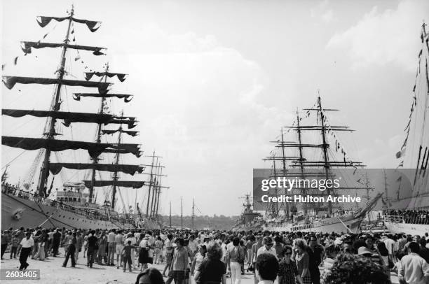 Tall sailing ships sit on display at a pier for the American Bicentennial celebration, July 1976.