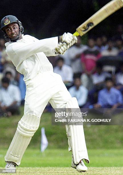 Bangladeshi cricketer Nasif Iqbal plays a shot to the boundary off English bowler Ashley Giles during the first day of a three day practice match...