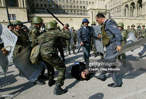 Soldiers beat an Opposition supporter of the Musavat party during riots October 16, 2003 in downtown Baku, Azerbaijan. People in this oil-rich...