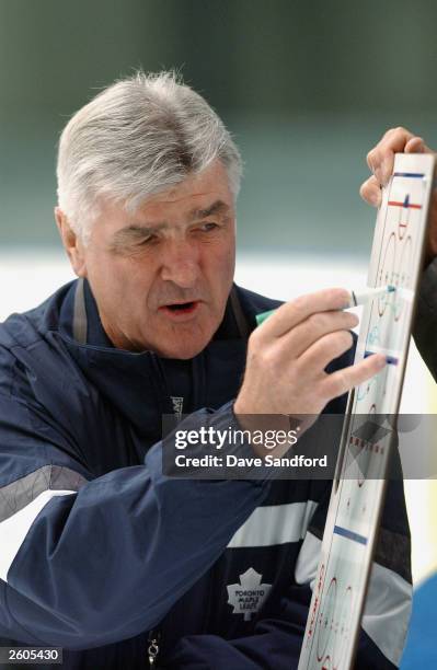 Head Coach Pat Quinn of the Toronto Maple Leafs goes over plays with his team during practice at the Globe Arena for the NHL Challenge 2003 on...
