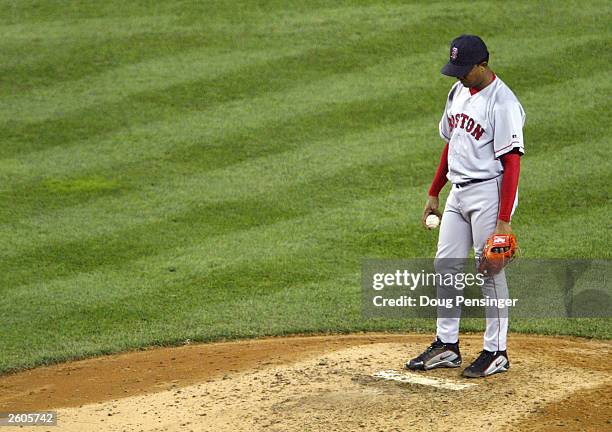 Pitcher Pedro Martinez of the Boston Red Sox hangs his head after giving up a solo home run to Jason Giambi of the New York Yankees in the seventh...