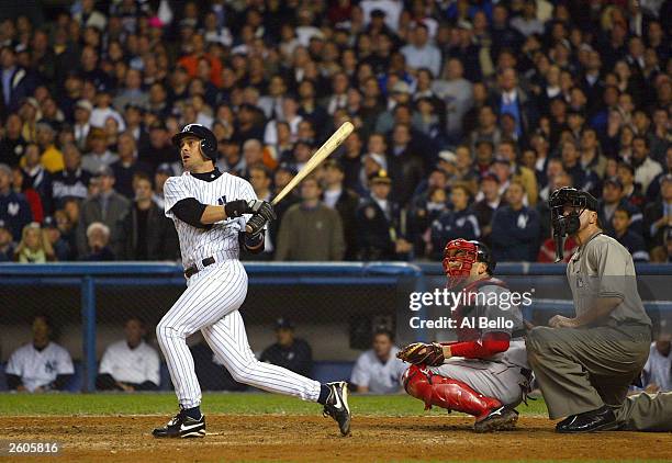 Aaron Boone of the New York Yankees hits the game winning home run in the bottom of the eleventh inning against the Boston Red Sox during game 7 of...