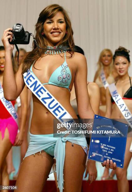 Year-old Miss Venezuela, Goizeder Azua shows off a winning plate and a camera after she was selected as Miss Photogenic during a Miss International...