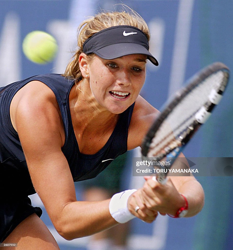 Ashley Harkleroad of USA stretches for the ball against Yan Zi of