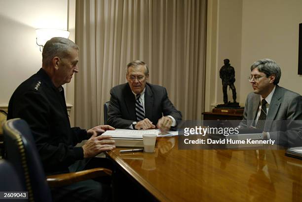 Secretary of Defense Donald Rumsfeld meets with CENTCOM commander General Tommy Franks and Under Secretary of Defense for Policy Douglas J. Feith at...