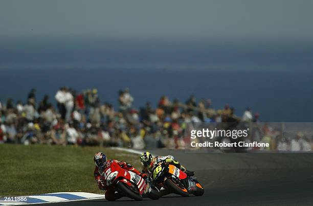 Troy Bayliss of Australia and Ducati is chased down by Valentino Rossi of Italy and during qualifying for the Skyy Vodka Australian Motorcycle Grand...