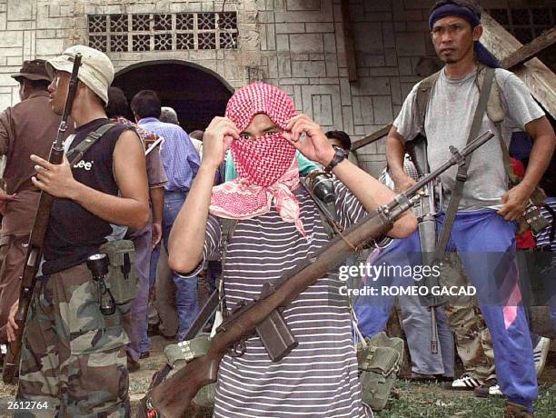 Photo taken 27 May 2000 shows Muslim Abu Sayyaf rebels holding Western hostages taking position outside the mosque in their stronghold in Jolo...