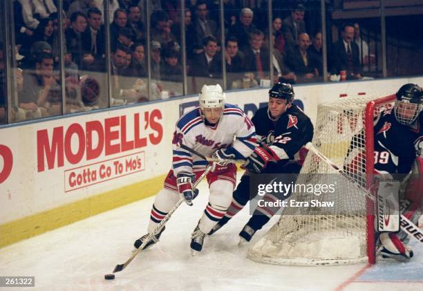 Pat LaFontaine of the New York Rangers is pursued by Wayne Primeau of the Buffalo Sabres during a game at Madison Square Garden in New York City, New...