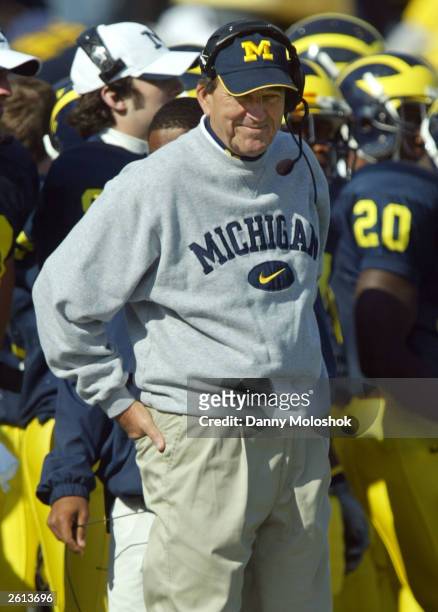 Head coach Lloyd Carr of the Michigan Wolverines smiles as he talks on his headset during his team's 56-14 win over the Illinois Fighting Illini...