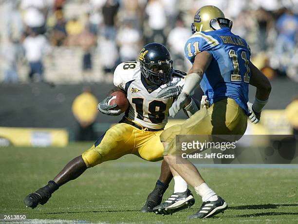 Adimchinobe Echemandu of the Cal Golden Bears is stopped on third down in overtime by Brandon Chillar of the UCLA Bruins during their game on October...
