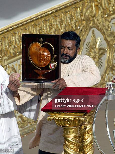 Brother Jesu Das Mannoopparampil of the Missionaries of Charity displays a relic of Mother Teresa, drops of blood, during the Beatification mass of...