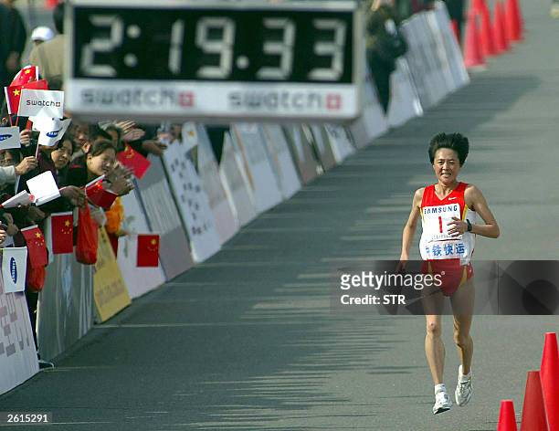 China's Sun Yingjie nearly at the finishing line in the women's race of the Beijing marathon, in Beijing 19 October 2003. China's up and coming...