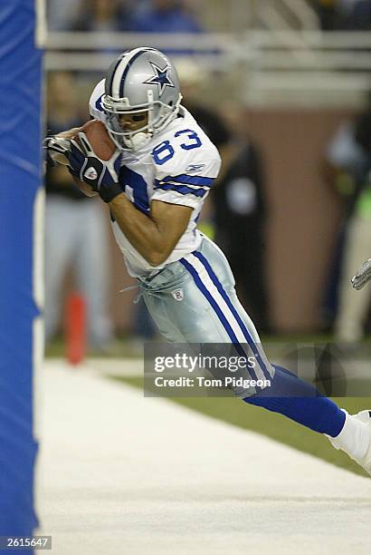 Terry Glenn of the Dallas Cowboys catches a touchdown pass in the first half against the Detroit Lions on October 19, 2003 at Ford Field in Detroit,...