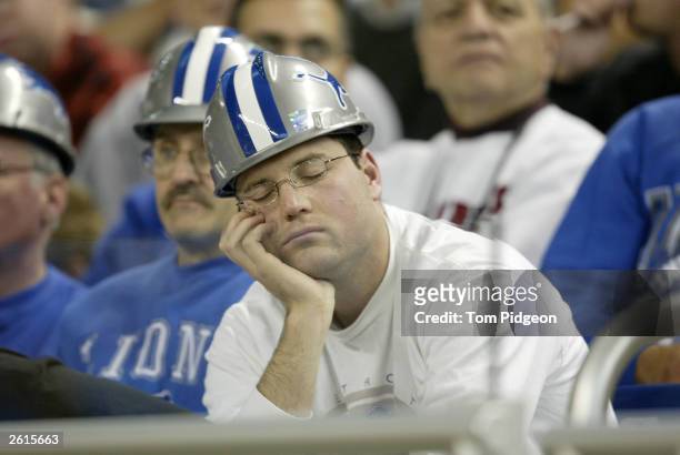 Detroit Lions fan closes his eyes in dismay after a Dallas Cowboys defensive touchdown in the first half against the Detroit Lions on October 19,...