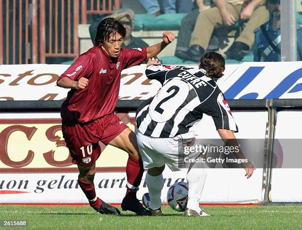 Shunsuke Nakamura of Reggina tries to get the ball past Leandro Damian Cufre of Siena during the Serie A match between Reggina and Siena at the...