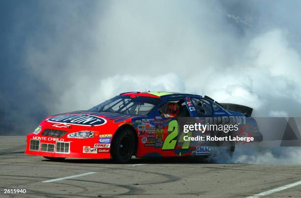 Jeff Gordon driving his Hendrick Motorsports Dupont Chevrolet does donuts and smokes his tires on the front stretch after winning the NASCAR Winston...