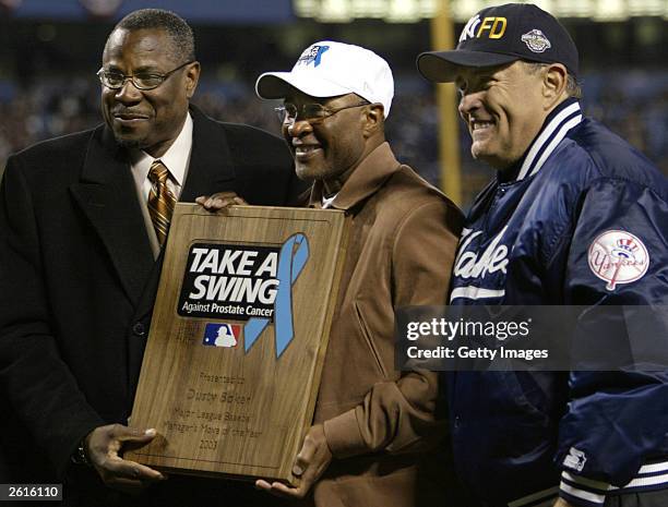 Ozzie Smith and former New York City Mayor Rudy Giuliani present Chicago Cubs manager Dusty Backer with the Manager's move of the year prior to game...