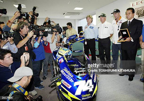 Photographers surround Takashi Kato , father of late Japanese world 250cc champion Daijiro Kato, Mick Doohan , Kenny Roberts and Angel Nieto during a...