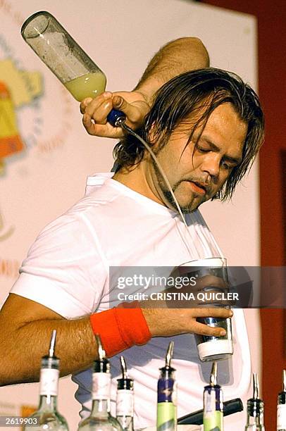 Norwegian Stig Barersten shows his skills during the 29 World Cocktail Competition in Seville, Spain 20 October 2003. AFP Photo Cristina Quicler