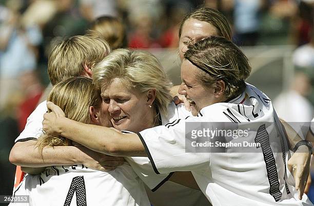 Nia Kuenzer and Martina Mueller of Germany celebrate with a teammate after defeating Sweden in the FIFA Women's World Cup Final on October 12, 2003...
