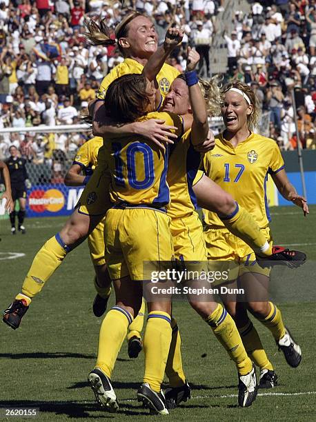 Hanna Ljungberg, Victoria Svensson and Anna Sjoestrom of Sweden celebrate a goal with teammates during the FIFA Women's World Cup Final on October...